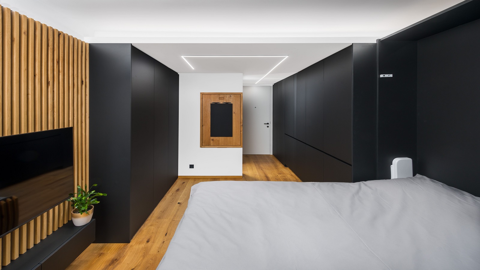 Folding studio with drop-down bed, wooden accents and black furniture