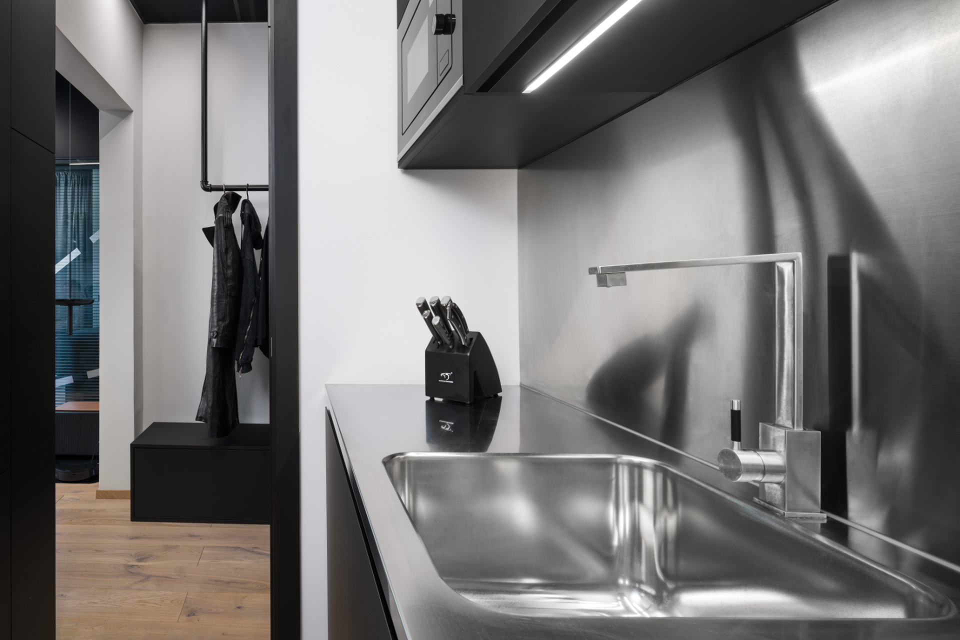 Modern stainless steel kitchen with knife holder, as an example of interior design