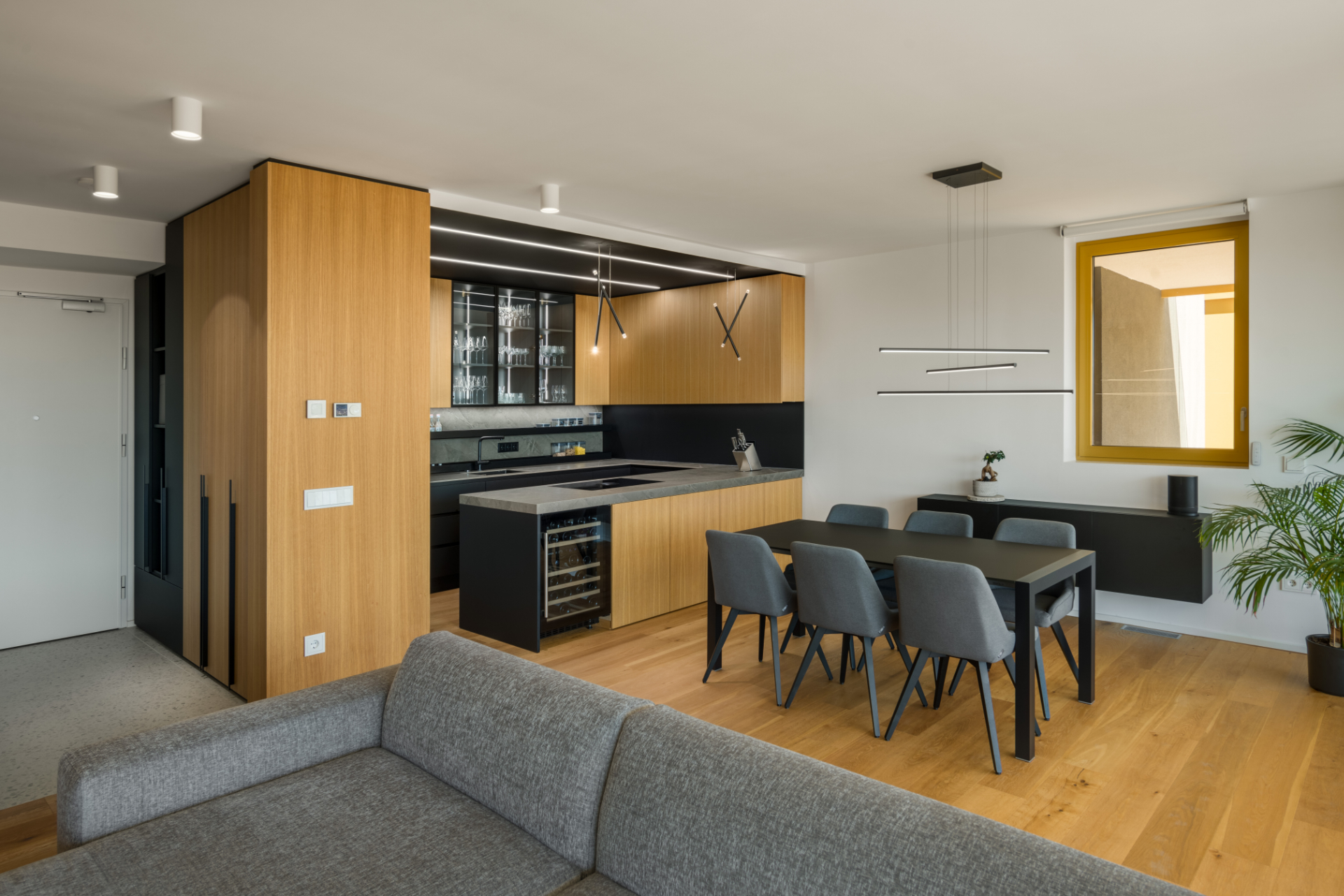 Interior design of a dining room and modern kitchen in a combination of wood and black