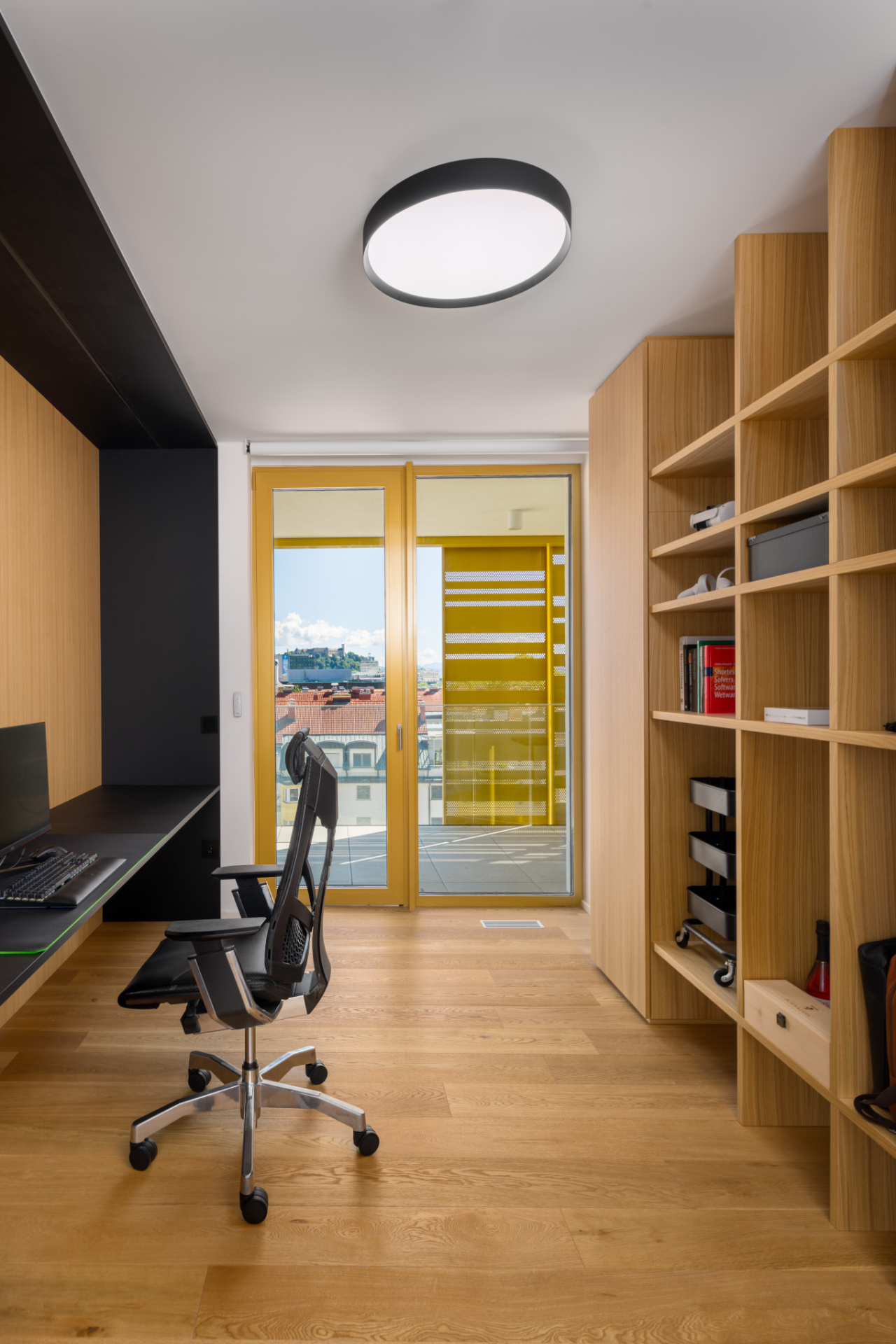 Home office with a balcony and a wooden built-in wardrobe