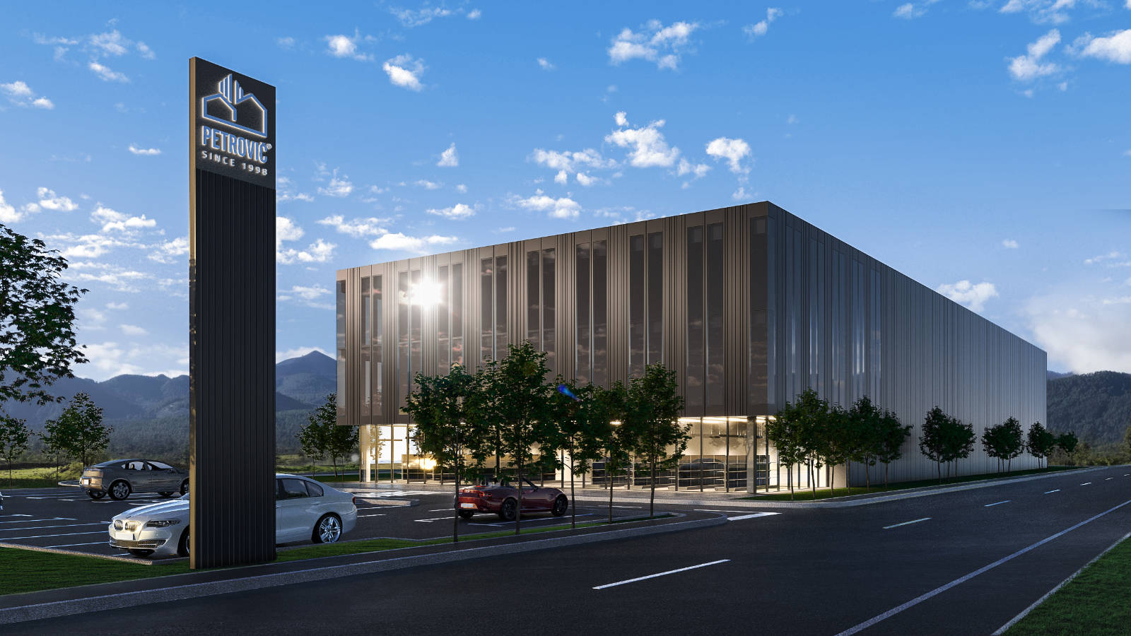 Poslovna stavba Petrovič z novo fasado in parkiriščem podnevi