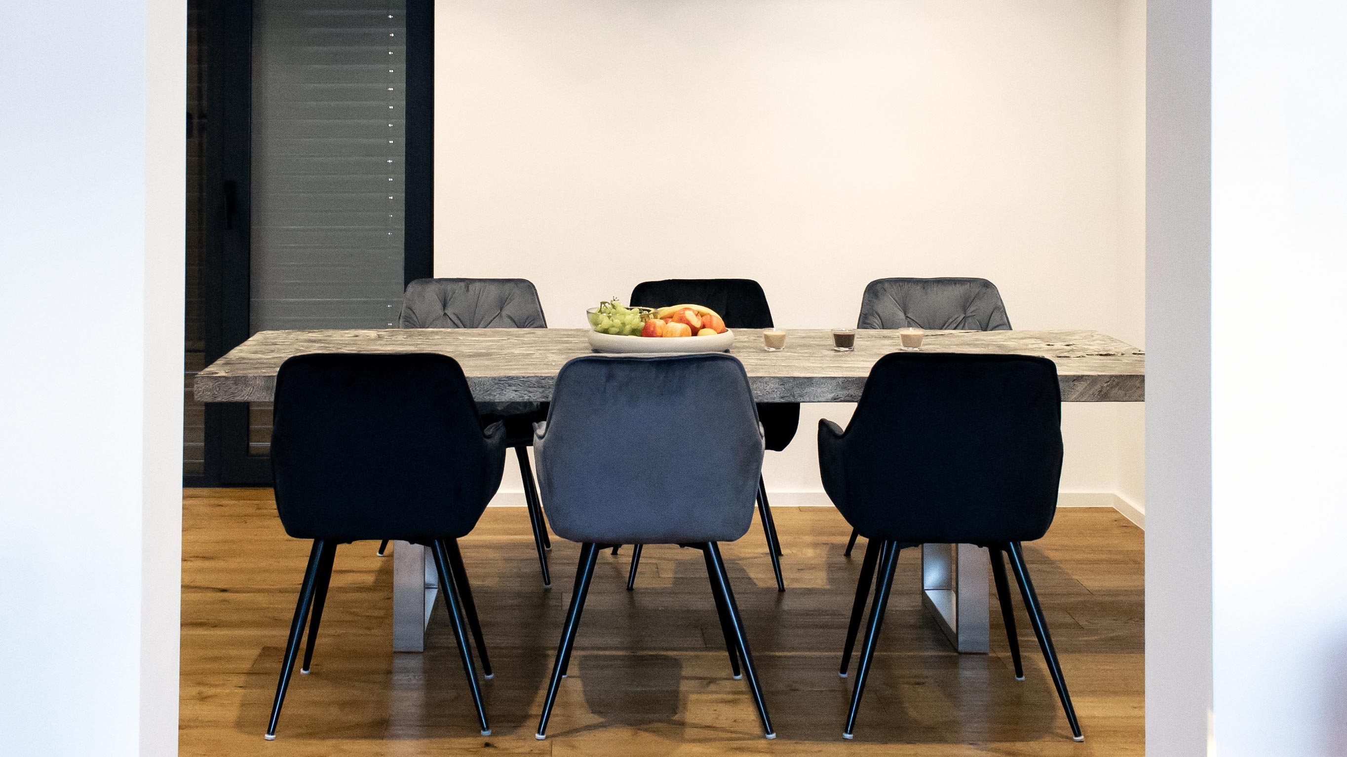 Jedilnica z leseno mizo v moderno oblikovanem interierju