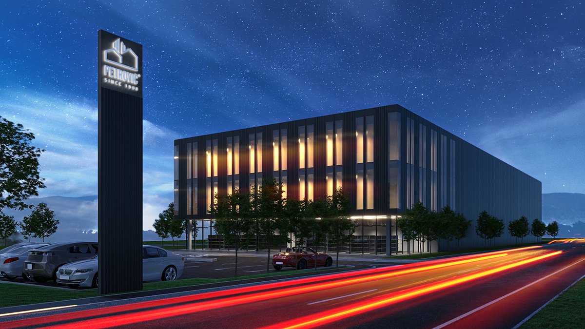 Petrovič office building with new facade and parking lot at night