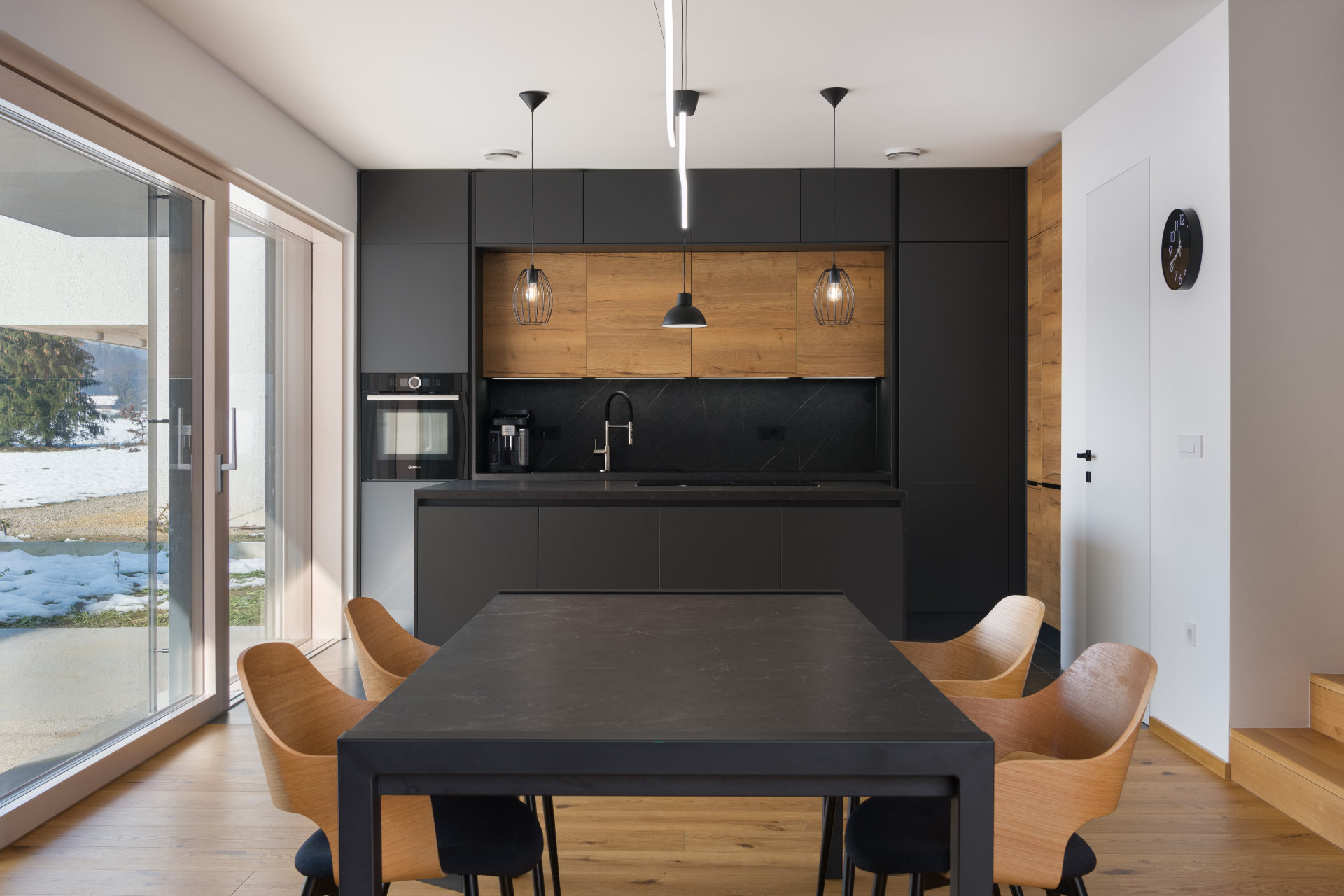 Dining room and kitchen in a modern interior with access to the terrace