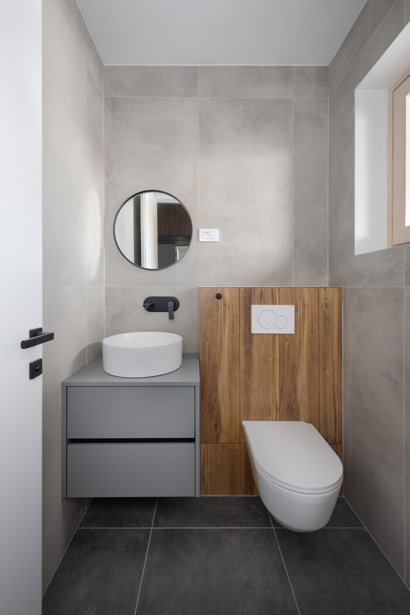 Toilet with wooden detail and gray anthracite walls, interior design example