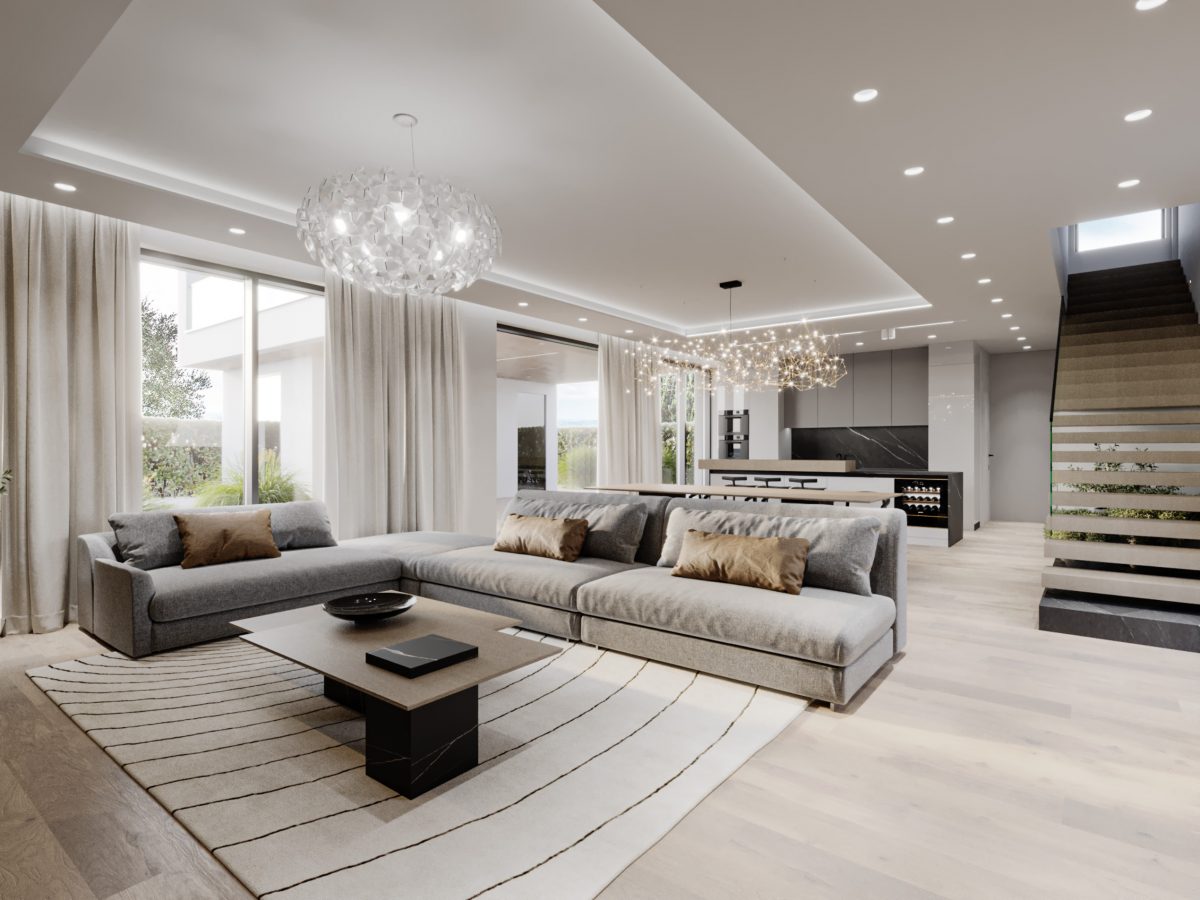 Svetel dnevni prostor s sedežno garnituro, moderno kuhinjo in jedilnico