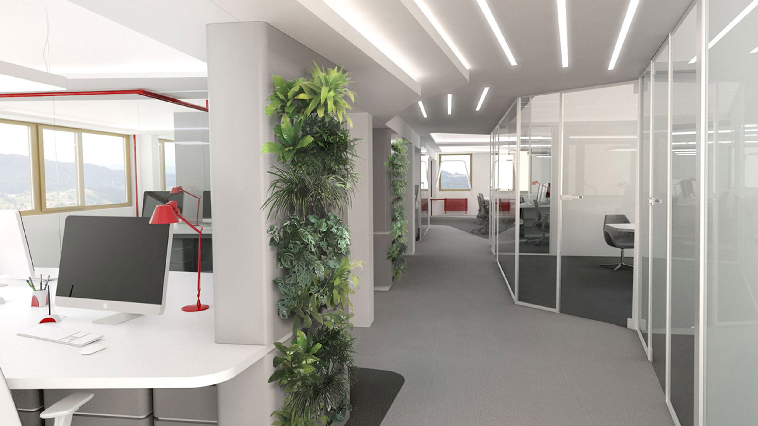 Bright office space with plants and tables on which computers and red lamps are placed