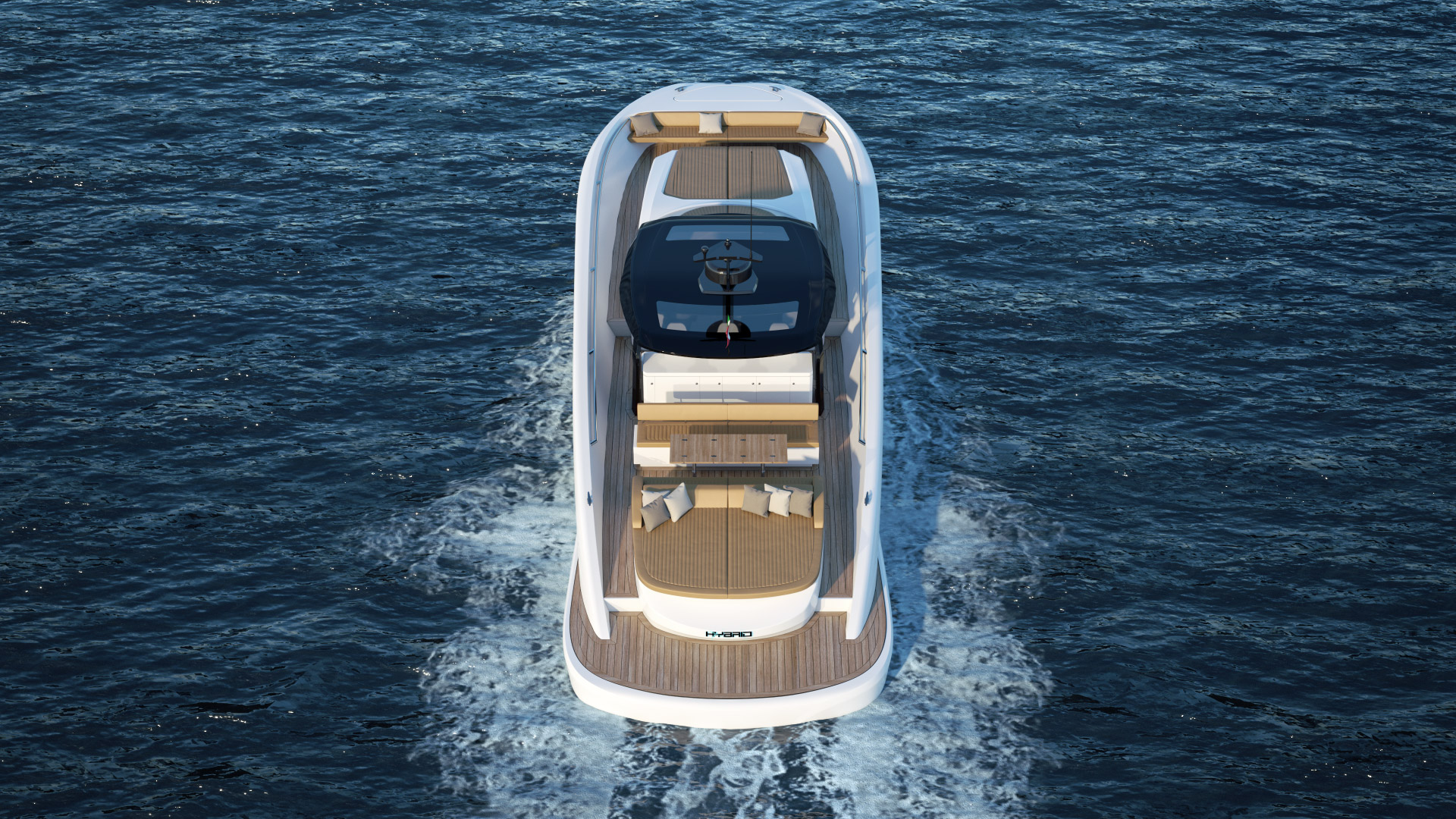 Zgornji pogled na leseno-belo jahto, ki pluje na morju ter ima, na zadnji palubi, mizo, ležišče in blazine