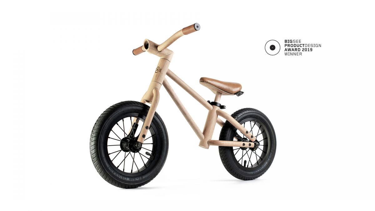 Wooden balance bike on a white background