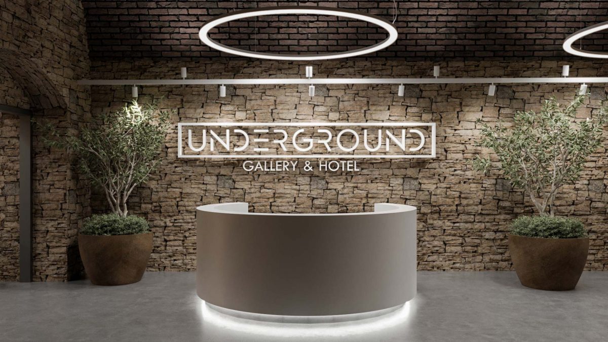 Reception at the Underground Hotel in a rustic brick-style with circular lights and plants